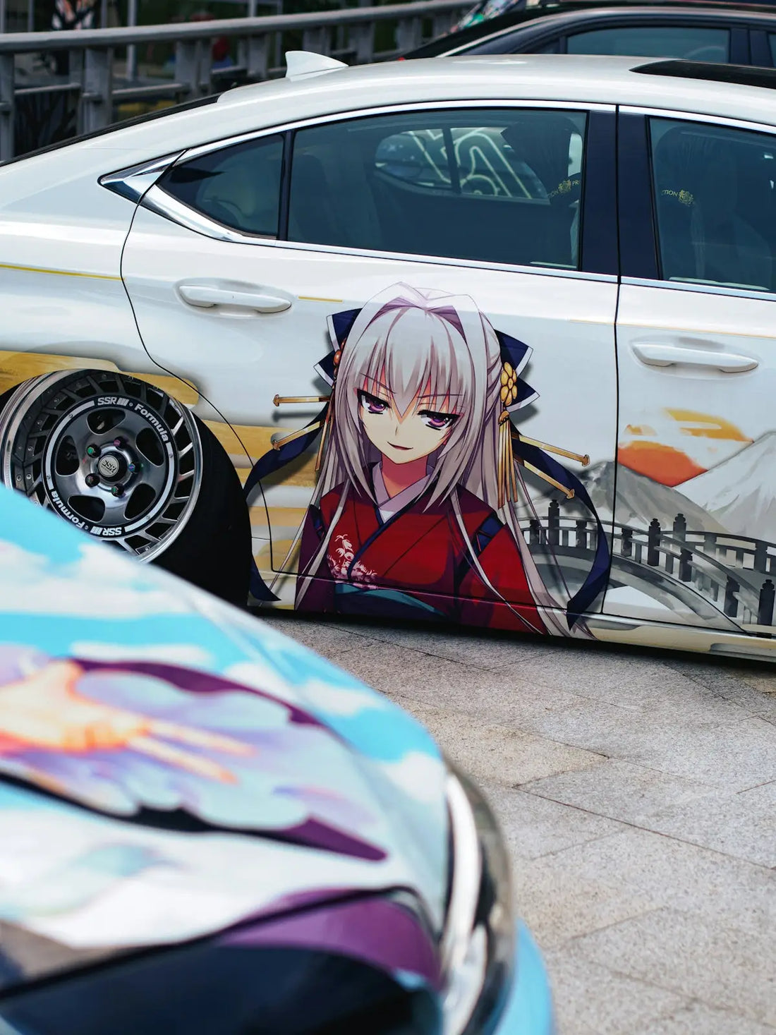A car painted with anime characters on it