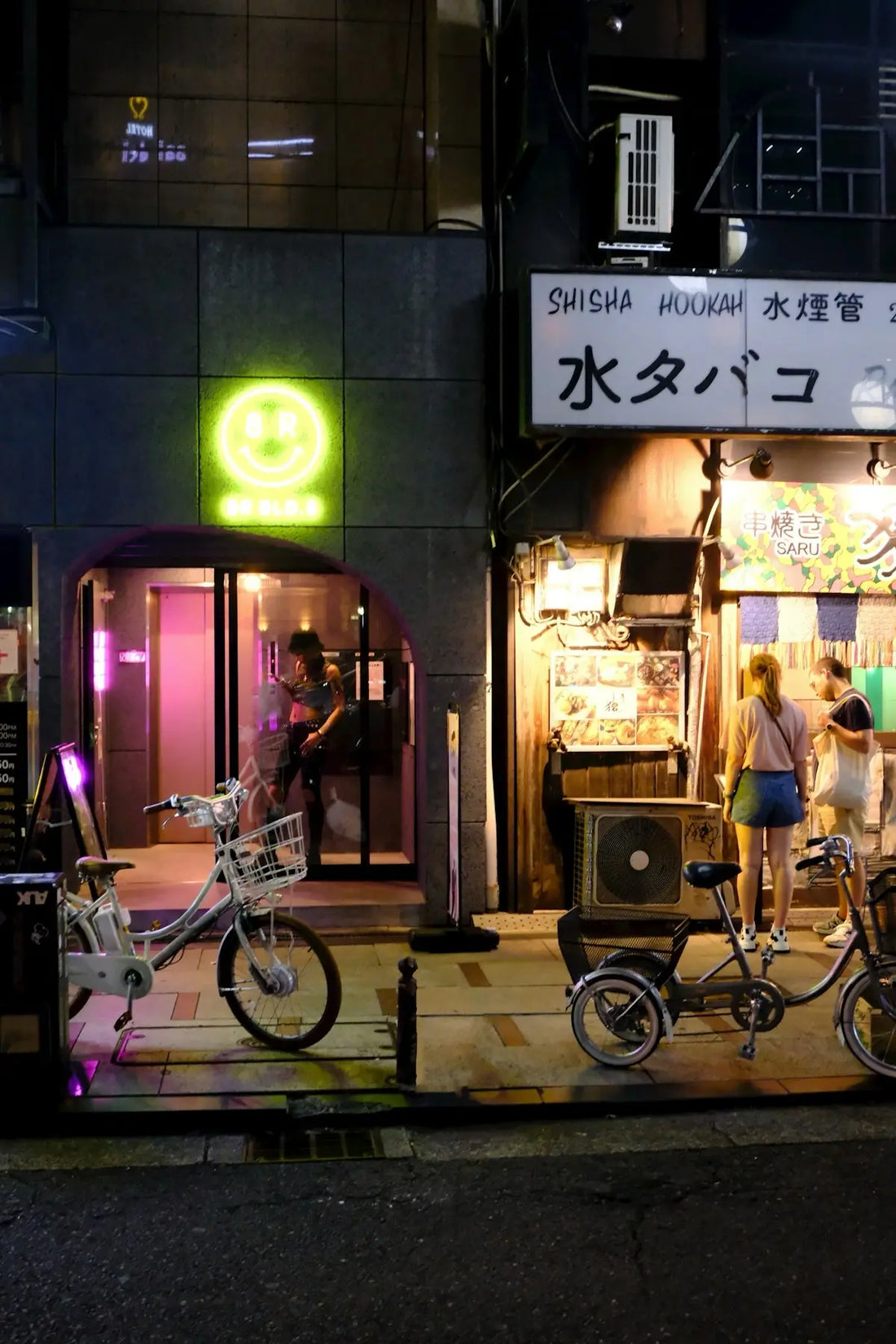 A couple of bikes parked in front of a store