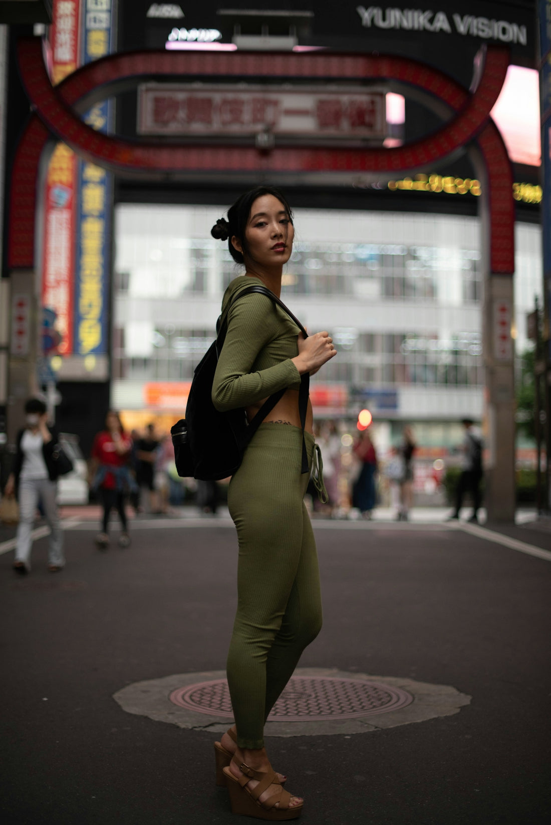 a woman standing in the middle of a street