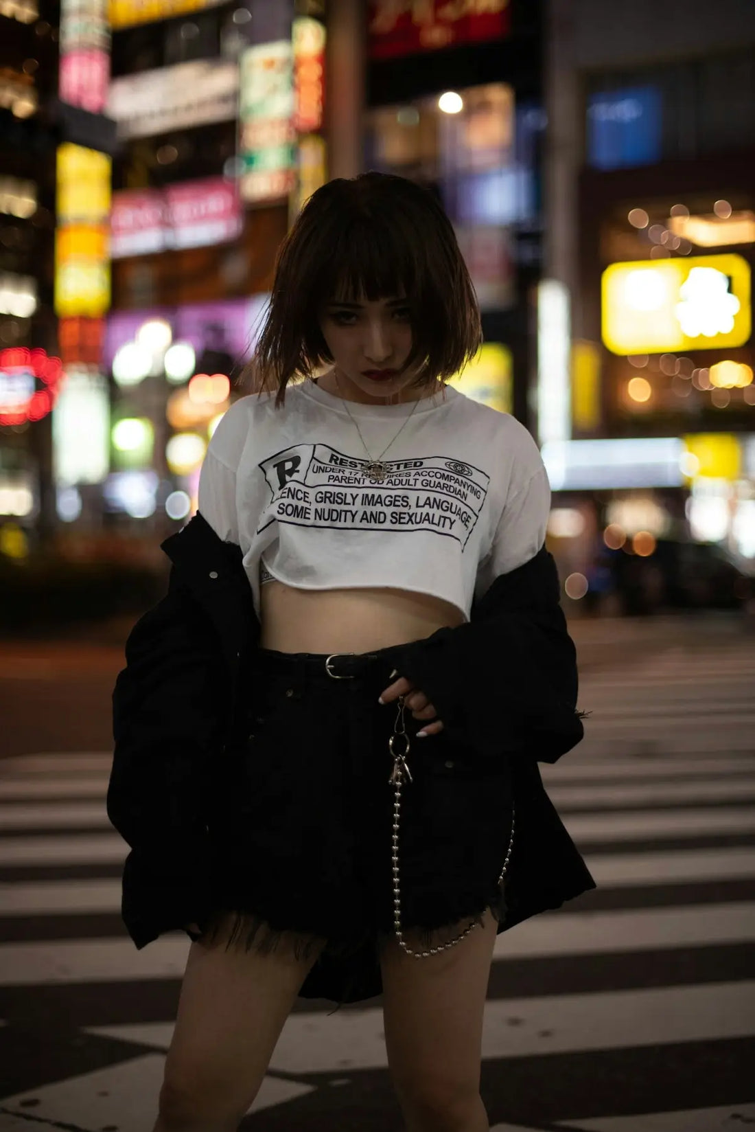 a woman standing in the middle of a cross walk