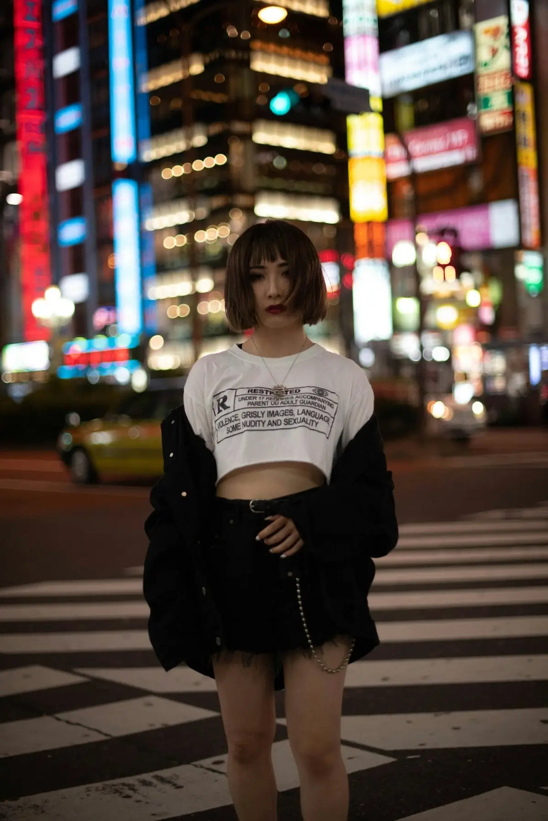 a woman standing in the middle of a cross walk